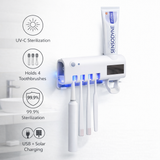 White toothbrush holder with UV-C sterilization, holding four toothbrushes and a tube of Sensodyne toothpaste.